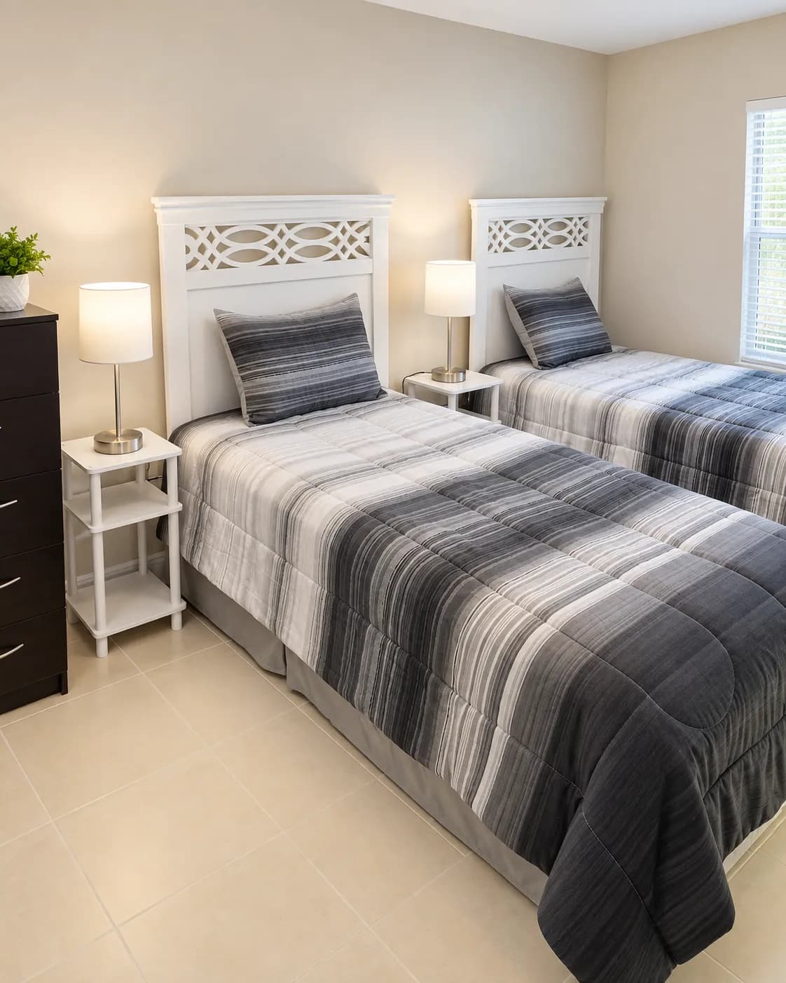 Resident twin bedroom with grey striped bedding